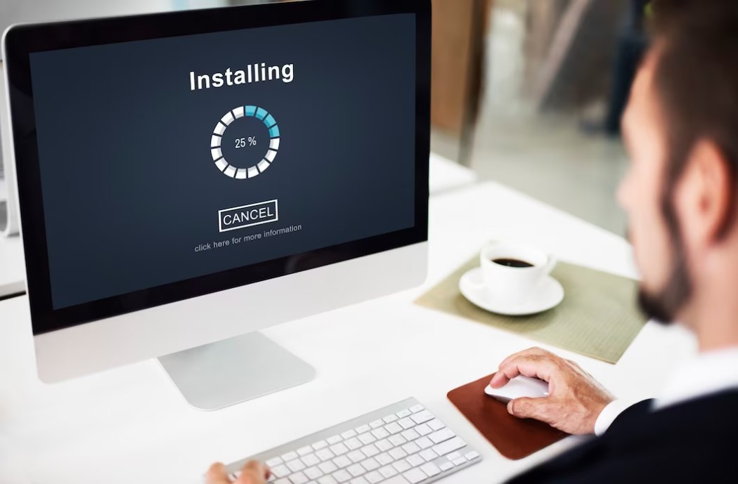 Man in suit using computer with installation on screen