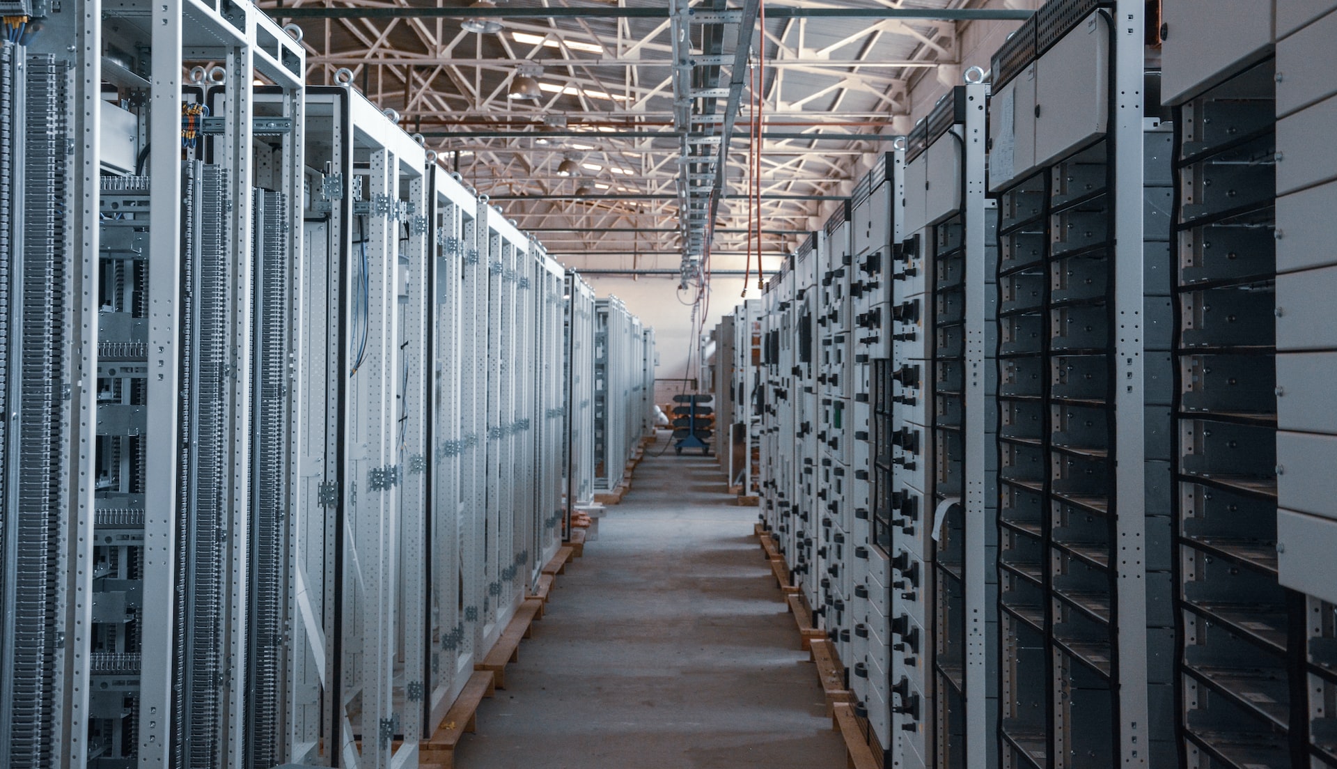 A row of metal racks in a warehouse specifically designed to house physical dedicated servers (VDS).