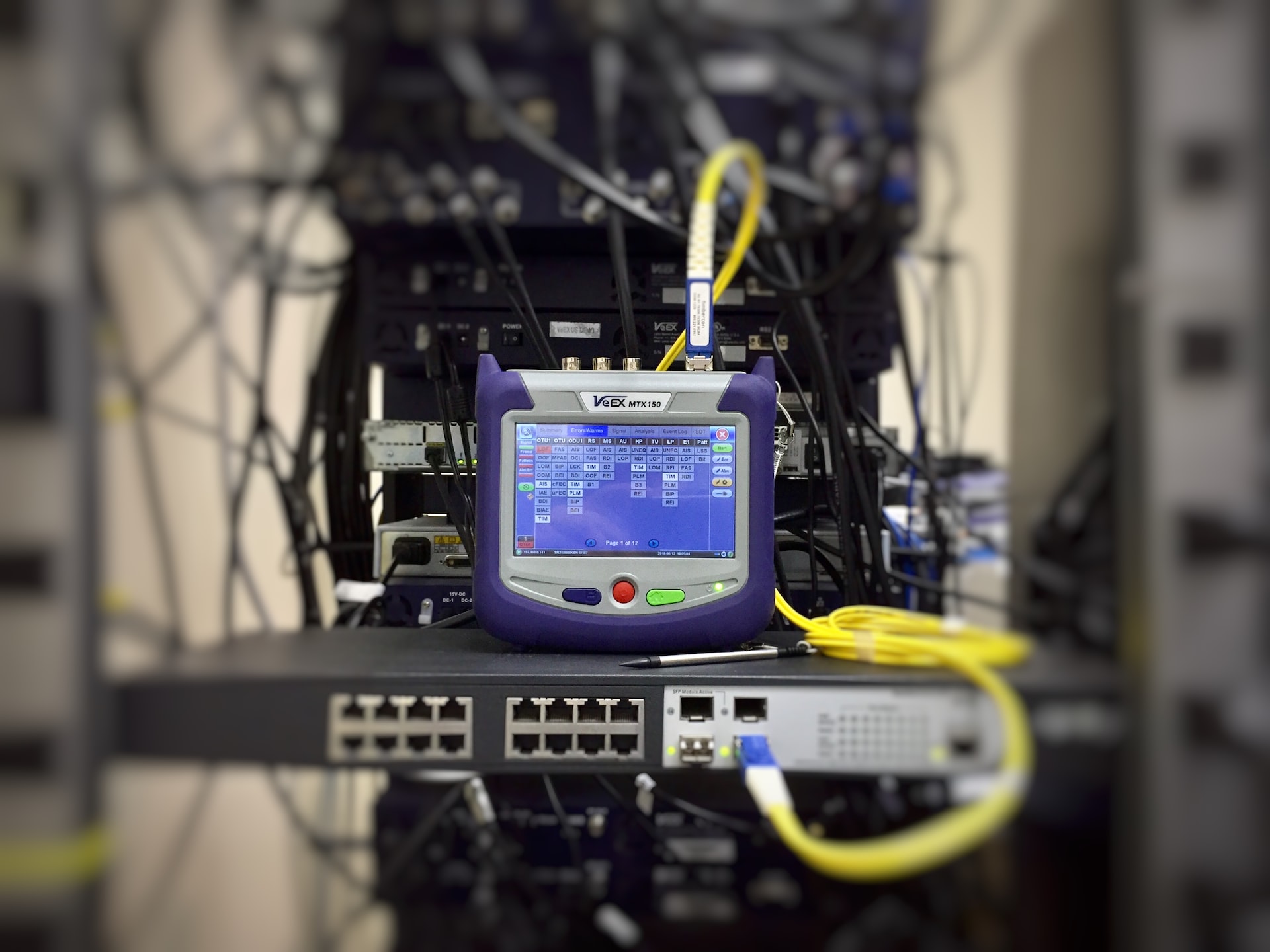 A monitor is sitting on top of a rack of wires in a cloud hosting environment.