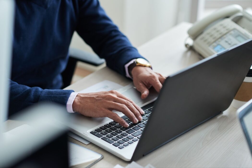 Close up of man typing on keyboard